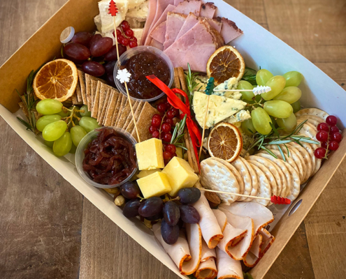 A selection of cheese and meats in ready for a Chrismas party